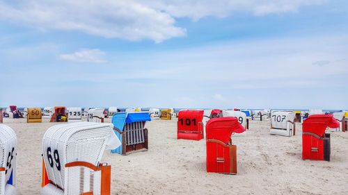 Multi colored umbrellas on beach against sky