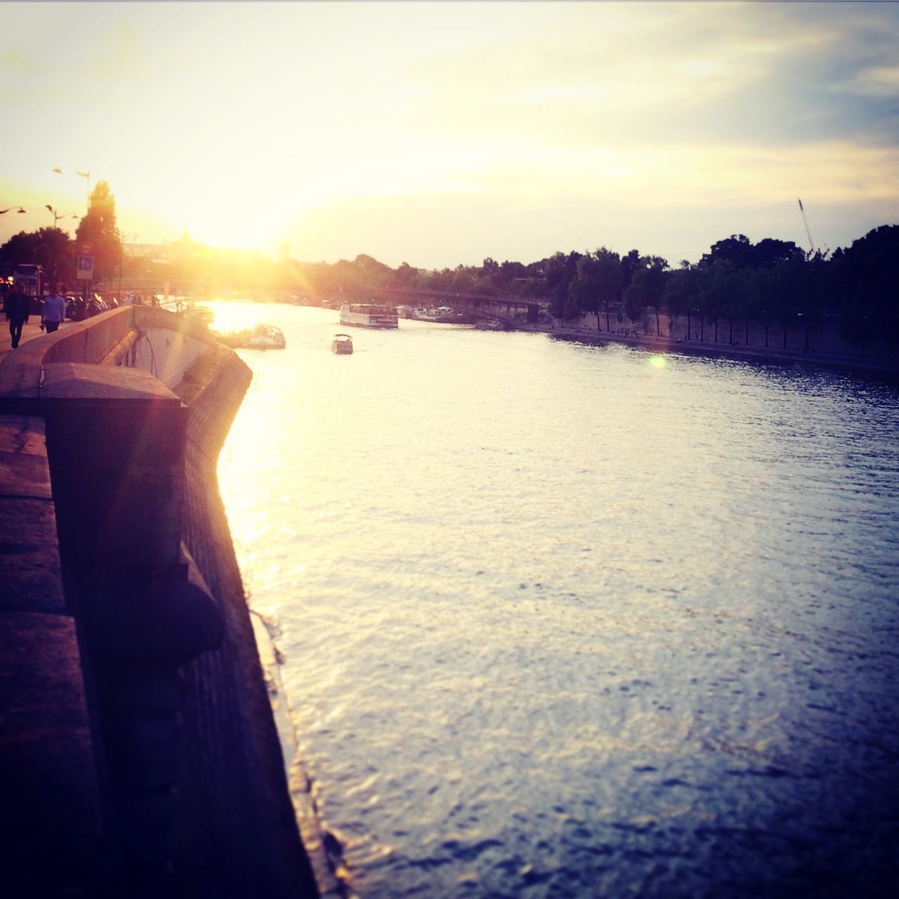 water, sunset, sky, sun, sea, sunlight, reflection, tranquility, river, tranquil scene, silhouette, scenics, transportation, nature, pier, beauty in nature, lake, sunbeam, nautical vessel, outdoors