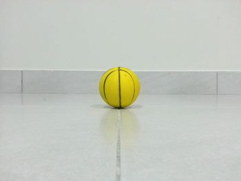 Close-up of yellow basketball on floor