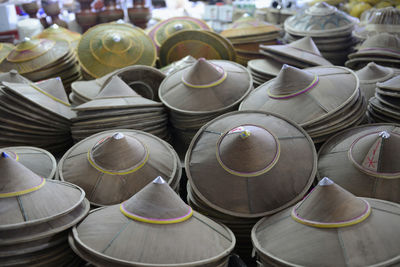 High angle view of asian style conical hats for sale