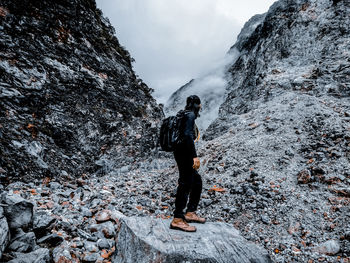 Rear view of man standing on rock