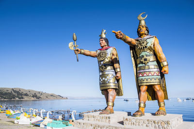 Statues of sun god and moon goddess at lake titicaca, bolivia