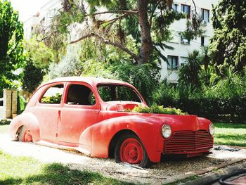 View of abandoned car against trees