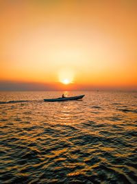 Scenic view of sea against orange sky