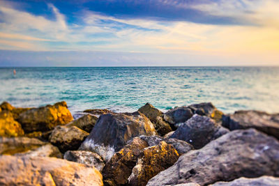 Close-up of rocks on beach against sky