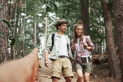 Young woman using mobile phone in forest