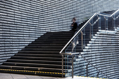 Low angle view of woman walking on staircase