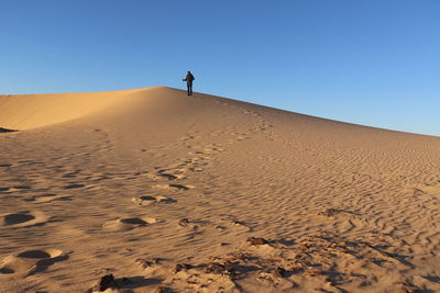 Scenic view of desert against clear sky