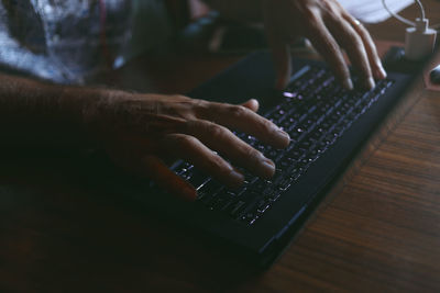 Close-up of hand using laptop