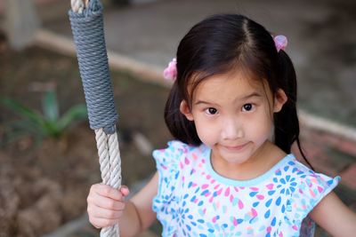 Portrait of cute girl holding camera