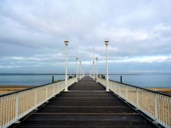 Pier over sea against sky