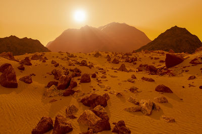 Scenic view of rocky mountains against sky during sunset