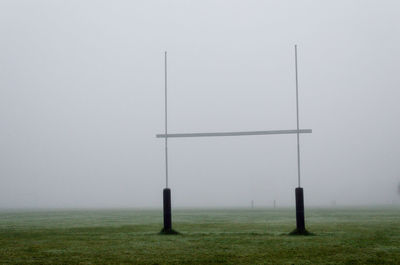 Fence on field against sky