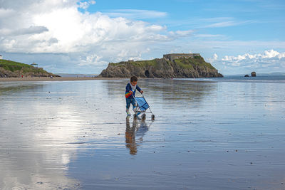 People on beach against sky