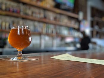 Close-up of beer glass on table