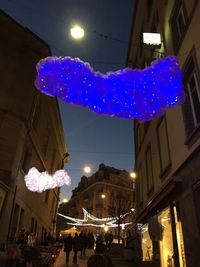 Low angle view of illuminated street light at night