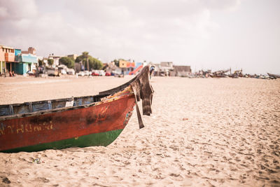 Boats moored on beach against sky