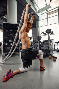 Full length of woman exercising in gym