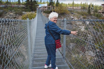 Full length of man standing on footbridge