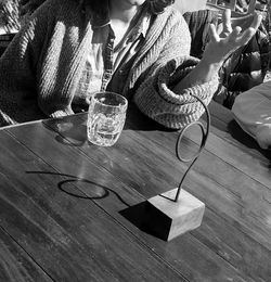 Low section of woman sitting on table