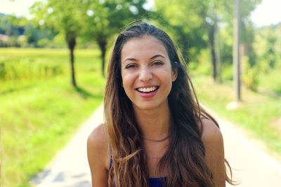 Portrait of smiling young woman at park