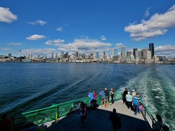 People on ferry deck sailing in sea