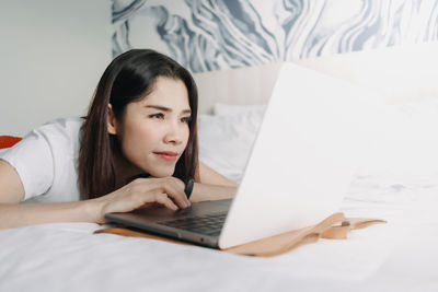 Young woman using laptop at home