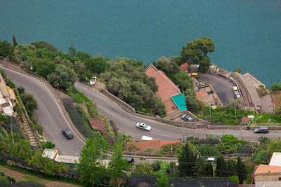 High angle view of road by trees and city