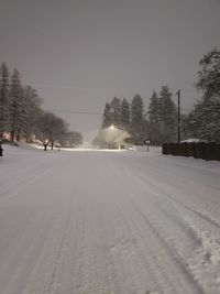 Snow covered street against sky