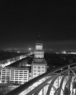 Illuminated cityscape against sky at night