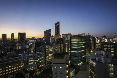 Aerial view of city lit up at night