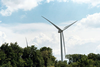 Low angle view of wind turbine against sky