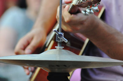 Midsection of man playing guitar