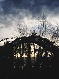 Low angle view of silhouette bare trees against sky