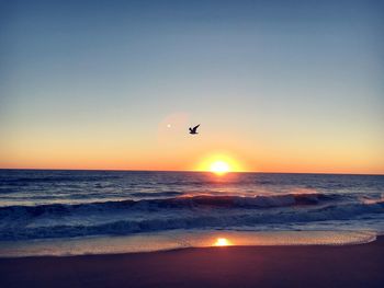 Scenic view of sea against clear sky during sunset