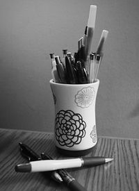 Close-up of paintbrushes on table against white background