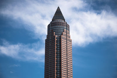 Low angle view of building against cloudy sky