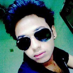 Close-up portrait of young man wearing sunglasses