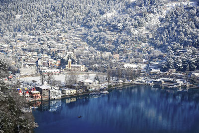 High angle view of townscape by river in city