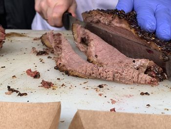 Midsection of man preparing food on table