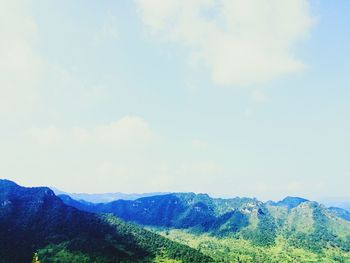 Scenic view of mountains against cloudy sky