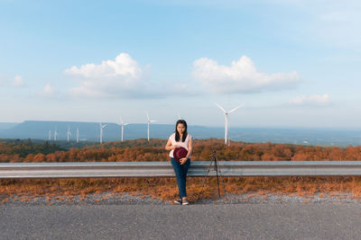 Full length of man standing on road against sky