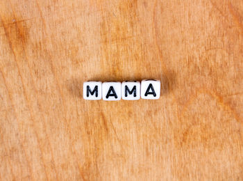 Close-up of information sign on wood