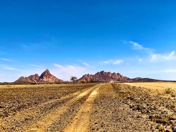Scenic view of arid landscape against sky