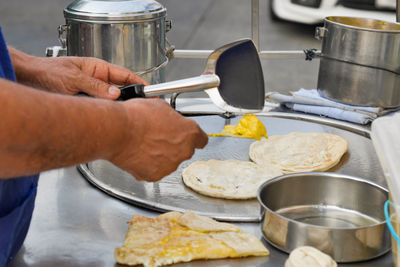 Midsection of man preparing food in kitchen