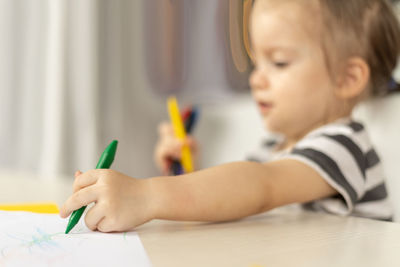 Boy drawing on book at home