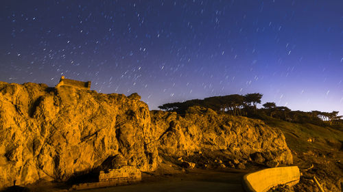 Scenic view of rock formation against sky at night