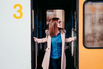 Woman standing by train