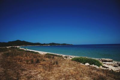 Scenic view of sea against clear blue sky
