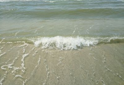 High angle view of waves rushing towards shore